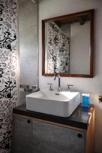a bathroom with a white sink and a mirror at Casa Atardecer San Javier in San Javier