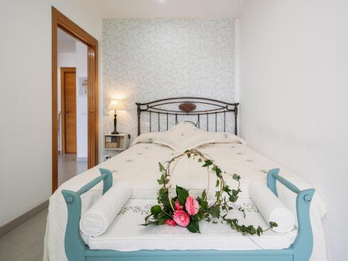 a bedroom with a bed with a flower arrangement on it at Casa Rural Viña Vella in Esteiro