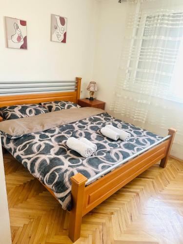 a bedroom with a bed with two towels on it at Centar Apartment in Kumanovo