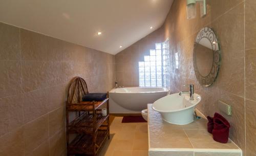 a bathroom with a tub and a toilet and a sink at Malee Beach F3 in Phra Ae beach