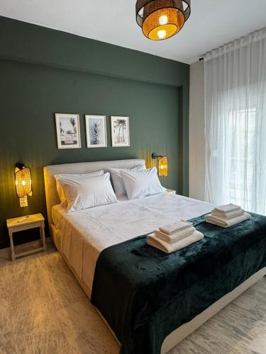 a bedroom with a large bed with two towels on it at Animus House #1 Apartment, Peraia in Perea