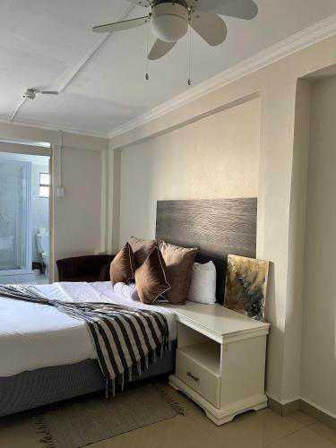 a bedroom with a bed and a ceiling fan at Montrose BnB in Margate