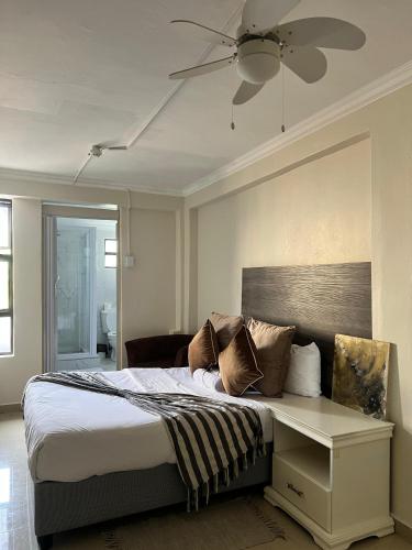 a bedroom with a bed and a ceiling fan at Montrose BnB in Margate