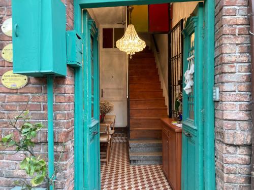 a doorway to a house with blue doors and a chandelier at Balat Boutique Hotel in Istanbul