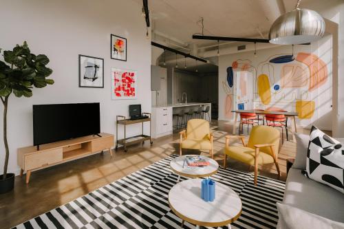 a living room with a couch and a tv at The Heid Lofts by Reside, a Wyndham Residence in Philadelphia