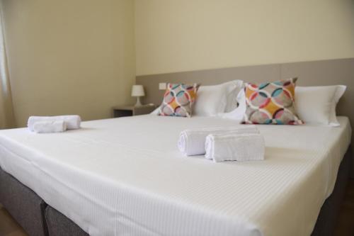 a large white bed with towels on top of it at Affittacamere Marilù in Paratico