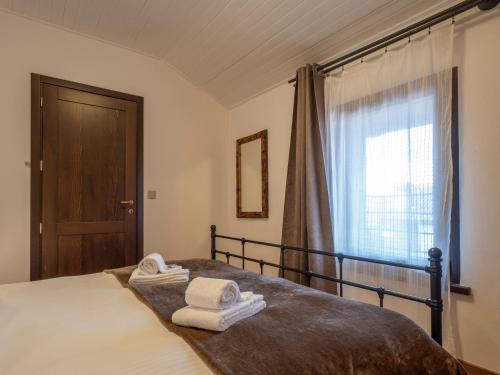 a bedroom with a bed with towels on it at Cjase Friûl in Cividale del Friuli