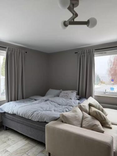 a bedroom with a large bed with a window at Siam Homestay in Mölndal