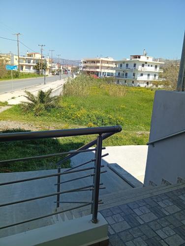 a bench with a rail next to a street at Memories Studio in Neapoli Voion