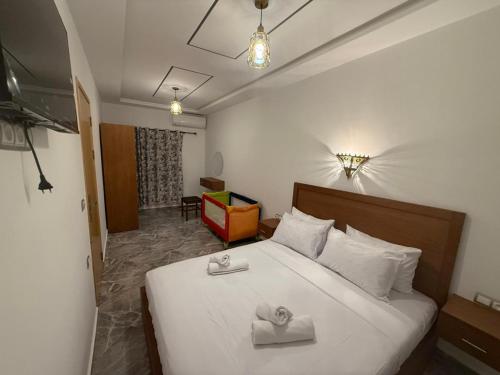 a bedroom with a bed with two towels on it at Casa Si Ahmed in Chefchaouen