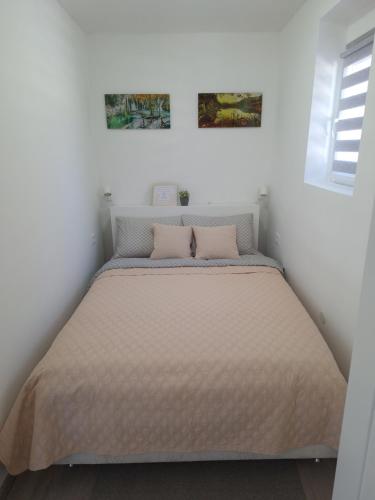 a bedroom with a large bed with two pillows at Studio apartment Cascada in Plitvička Jezera