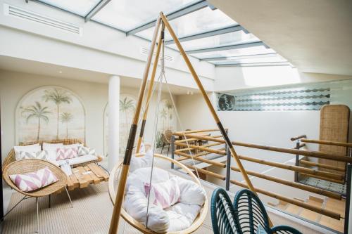 a room with a hammock and a swing at The Salty Lodge in Lagos