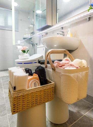 a bathroom with a sink and a toilet and towels at 홍대 골든스테이 in Seoul