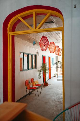 an open doorway to a room with chairs and lights at Maka Hostel in Oaxaca City