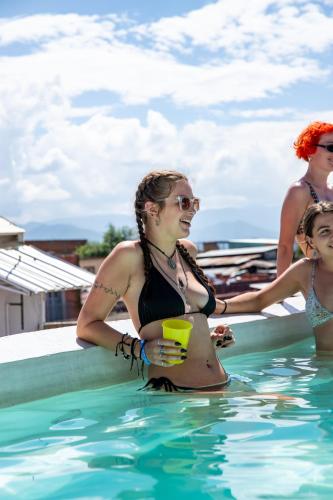 a group of women sitting in a swimming pool at Maka Hostel in Oaxaca City