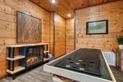 a living room with a fireplace in a log cabin at Dreamers Oasis in Sevierville