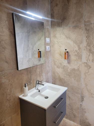 a bathroom with a sink and a mirror at Villa Pavone in Coreglia Antelminelli