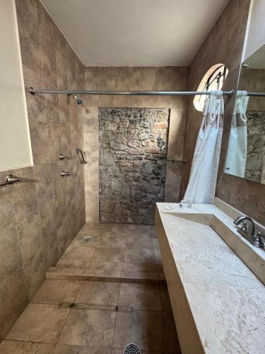 a bathroom with a shower and a sink at Cachito Mio hotel y temazcal in Cholula