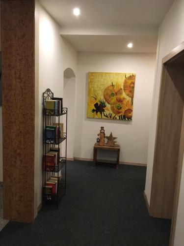 a room with a painting on the wall and a shelf at Gästehaus am Lindenhain in Erding