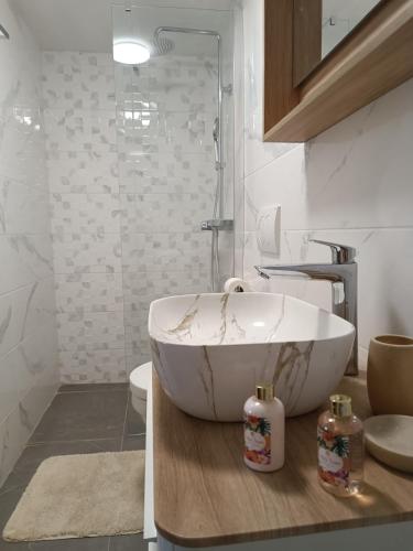 a bathroom with a large white bath tub on a counter at Apartmani Lili in Crikvenica