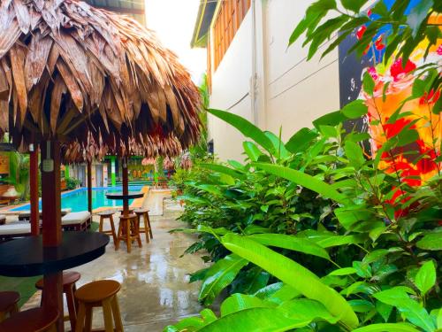 a restaurant with tables and chairs and a pool at Amazon City in Pucallpa