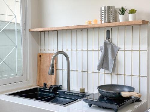 a kitchen with a sink and a bowl on a counter at Abundant Eco Hostel in Laguna Phuket