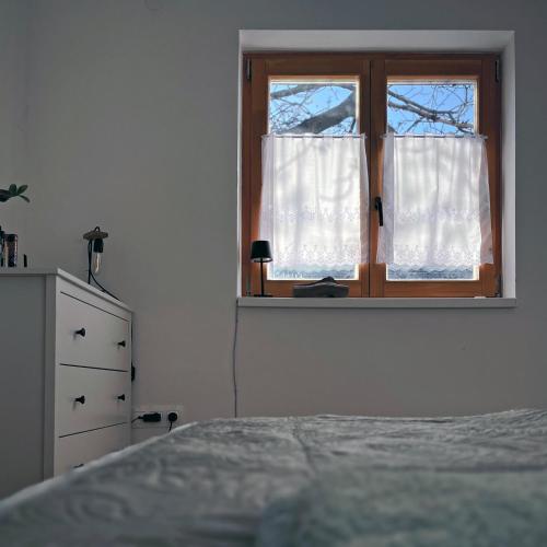 a bedroom with a bed and a window at Kisház in Kisoroszi