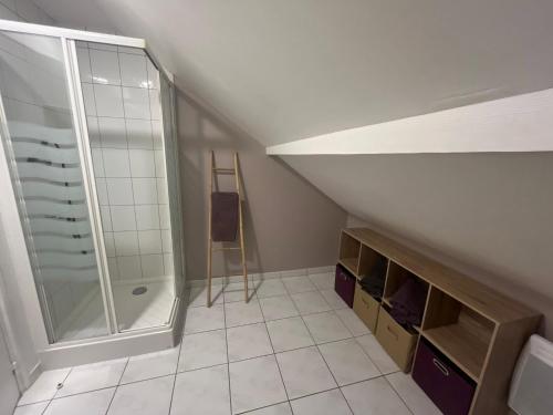 a attic bathroom with a shower and a ladder at Studio Chalet des Pistes in Gérardmer