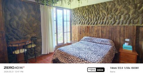 a bedroom with a bed in a room with a window at "De HugoS" hospedaje in Ibarra