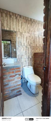a bathroom with a white toilet and a sink at "De HugoS" hospedaje in Ibarra