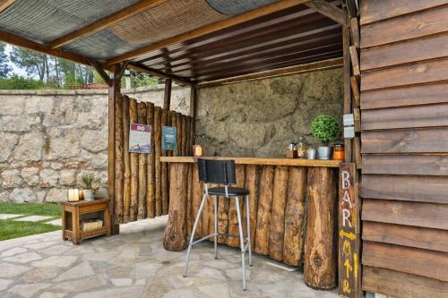 a bar in a wooden building with a stool at Quinta do Regato Douro in Penafiel
