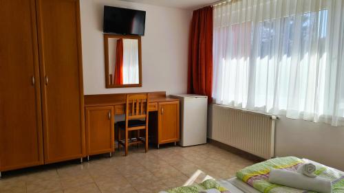 a small room with a desk and a table with a chair at Rider Beach in Balatonszemes