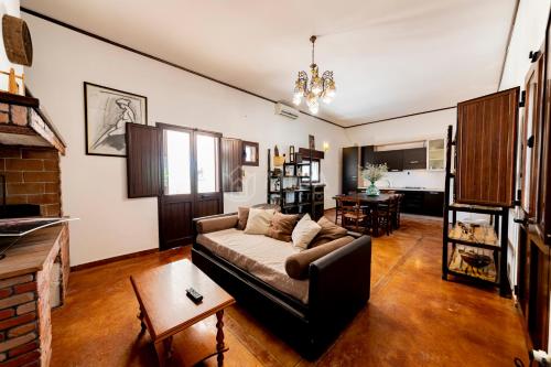 a living room with a couch and a table at Villa Oasis in Torre Lapillo