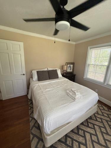 a bedroom with a bed with a ceiling fan at Lux Minimum 2 Lexington With Riverwalk & CAE in West Columbia