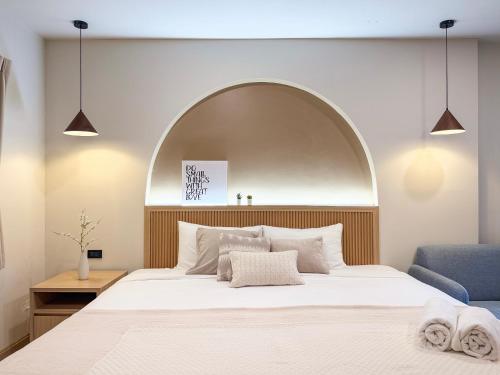 a bedroom with a large bed with an arch above it at Abundant Eco Hostel in Laguna Phuket