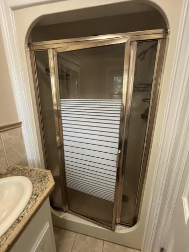 a glass shower in a bathroom with a sink at Lux Minimum 2 Lexington With Riverwalk & CAE in West Columbia