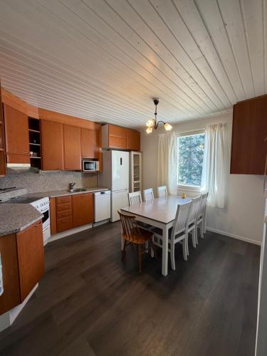 a kitchen with a table and chairs in a room at Apartment Koivikkotie in Savonlinna