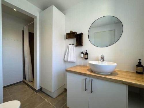 a bathroom with a white sink and a mirror at 20334-Samso-Kaerbakken-13 in Hårdmark