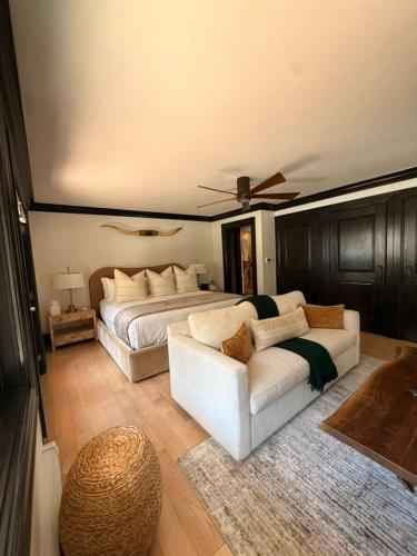 a bedroom with a bed and a white couch at Spacious 3 & 3 in Aspen's Core with Sauna in Aspen