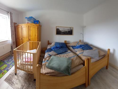 a bedroom with a large bed with blue pillows at Ferienwohnung Finkenberg in Sebnitz