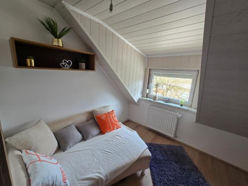 a living room with a couch and a staircase at Ferienwohnung U28 in Ferlach