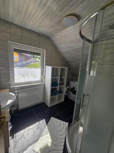 a small bathroom with a shower and a sink at Ferienwohnung U28 in Ferlach