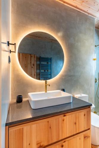 a bathroom with a sink and a mirror at Casa Aromas in Santo Amaro