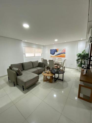 a living room with a couch and a table at Edificio Juan XXIII - 2 Dormitorios - Zona Shopping Del Sol in Asunción