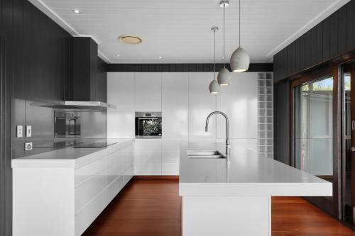 a kitchen with white counters and a white counter top at Dolphins at Sunset in Amity Point