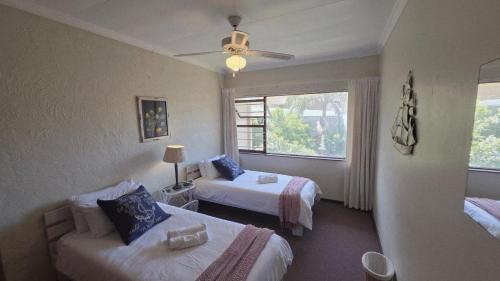 a hotel room with two beds and a window at Beach Bliss Retreat in Margate