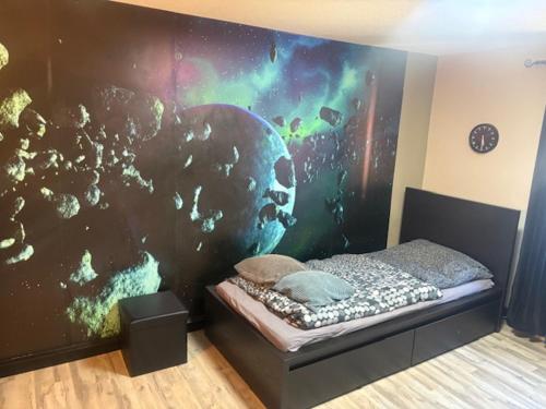 a bedroom with a wall with a skull mural at Gästehaus Graupner in Hainichen
