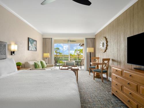 a hotel room with a bed and a flat screen tv at Hyatt Vacation Club at Coconut Cove in Bonita Shores
