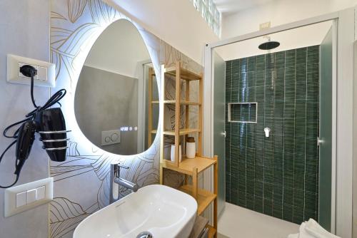 a bathroom with a sink and a mirror at Gioia e Relax di ZR in Rho