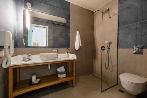 a bathroom with a sink and a shower at Noera in Skiathos